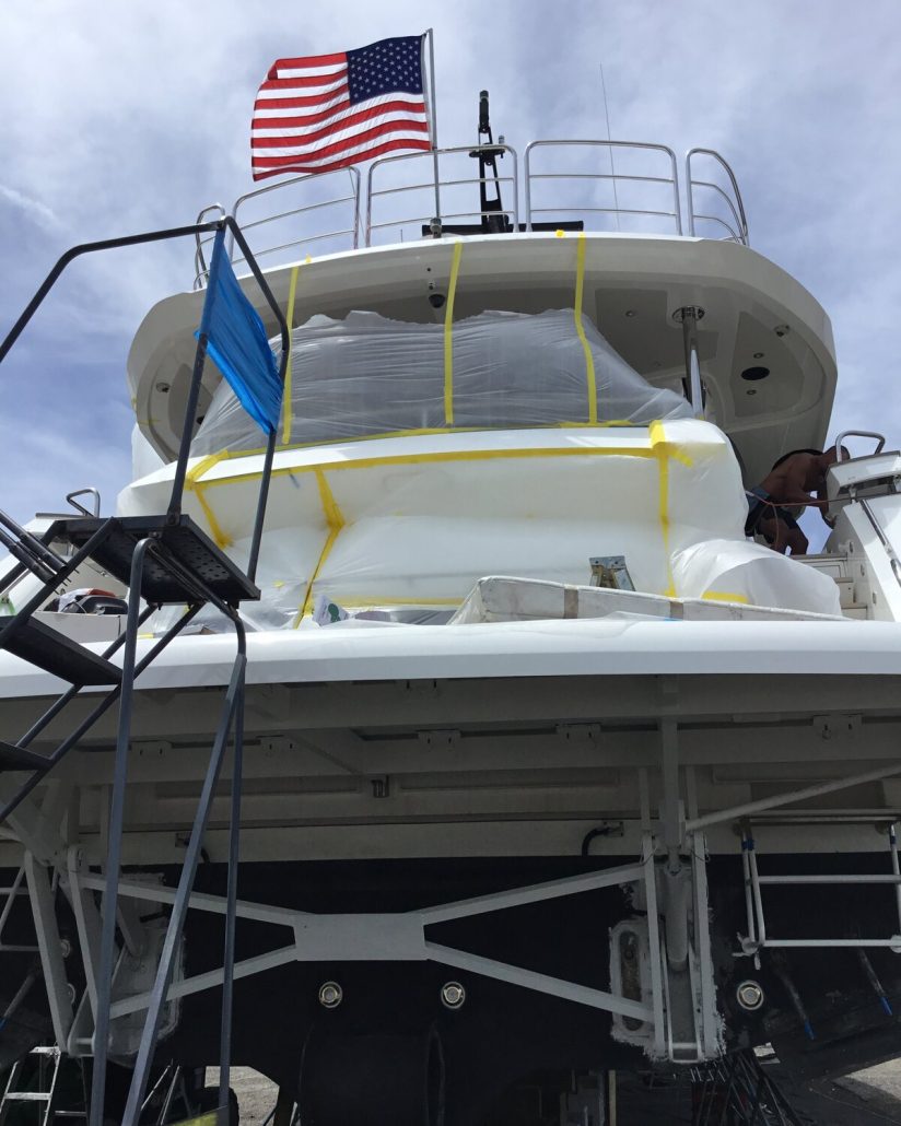 Sunseeker stern with adjacent surfaces masked during exterior work