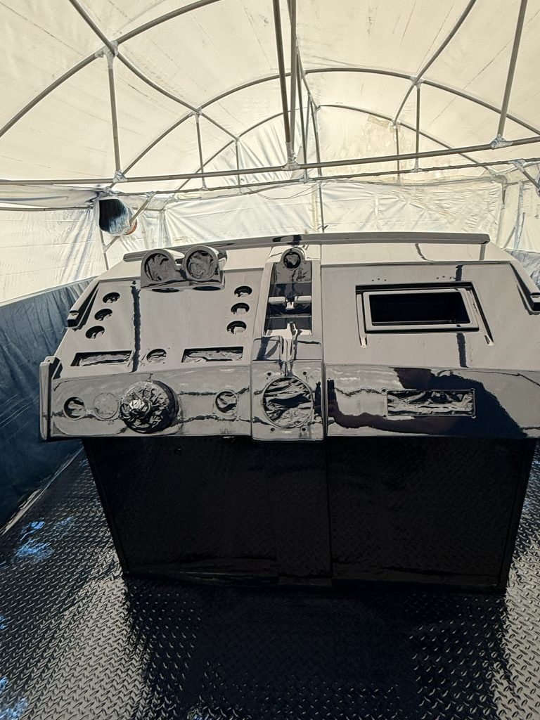 Dark painted boat console with instrument openings masked inside the enclosure