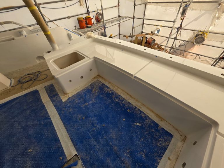 Sunseeker 74 cockpit seating and ledges after Awlgrip painting, with blue deck protection