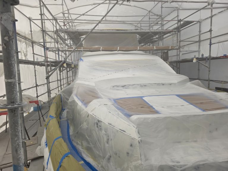 Sunseeker 74 foredeck and glazing covered during preparation inside the scaffold enclosure
