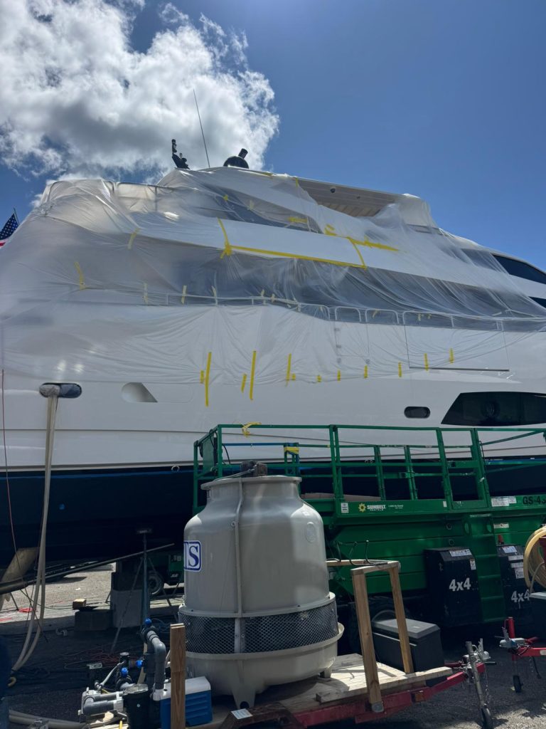 Sunseeker upper exterior with extensive protective sheeting and an access platform alongside