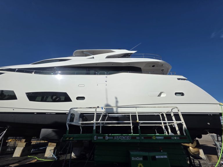 Sunseeker exterior profile ashore with white hull, dark windows and yard access equipment