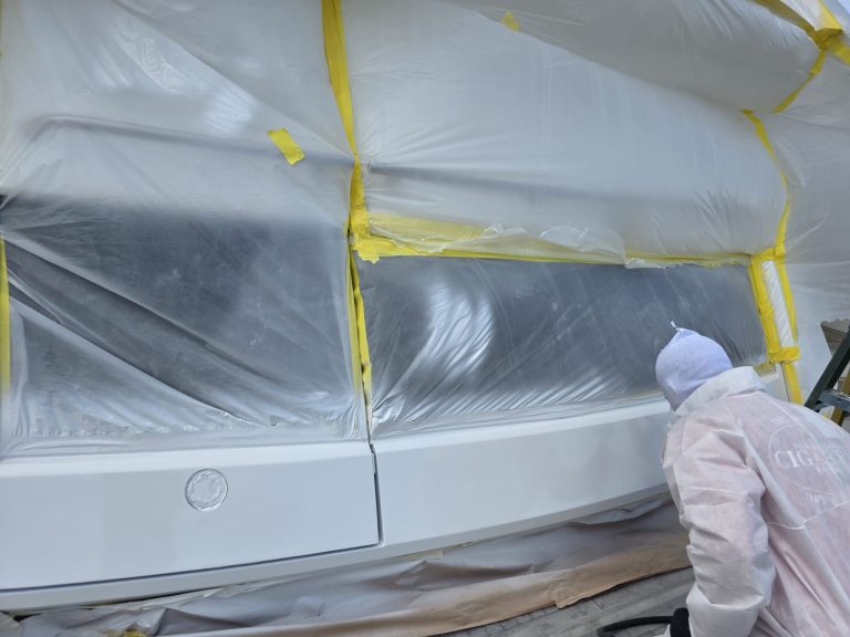 Technician working on the Sunseeker exterior beside masked glazing and fittings